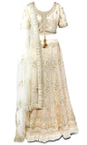 Creme shimmering colored lehenga covered in beautiful embroidery in shades of creme, off-white, gold and silver.