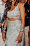Light blue mermaid-style lehenga by Sherri Hill with long skim skirt & sleeveless crop top