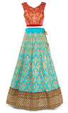 contrasting blue lehenga Spicy mami, hot tamale. The red silk top is embellished with gold threadwork and pink flowers.