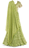 Lime green lehenga paired with a matching skirt and jeweled dupatta with fringe takes it to the next level.
