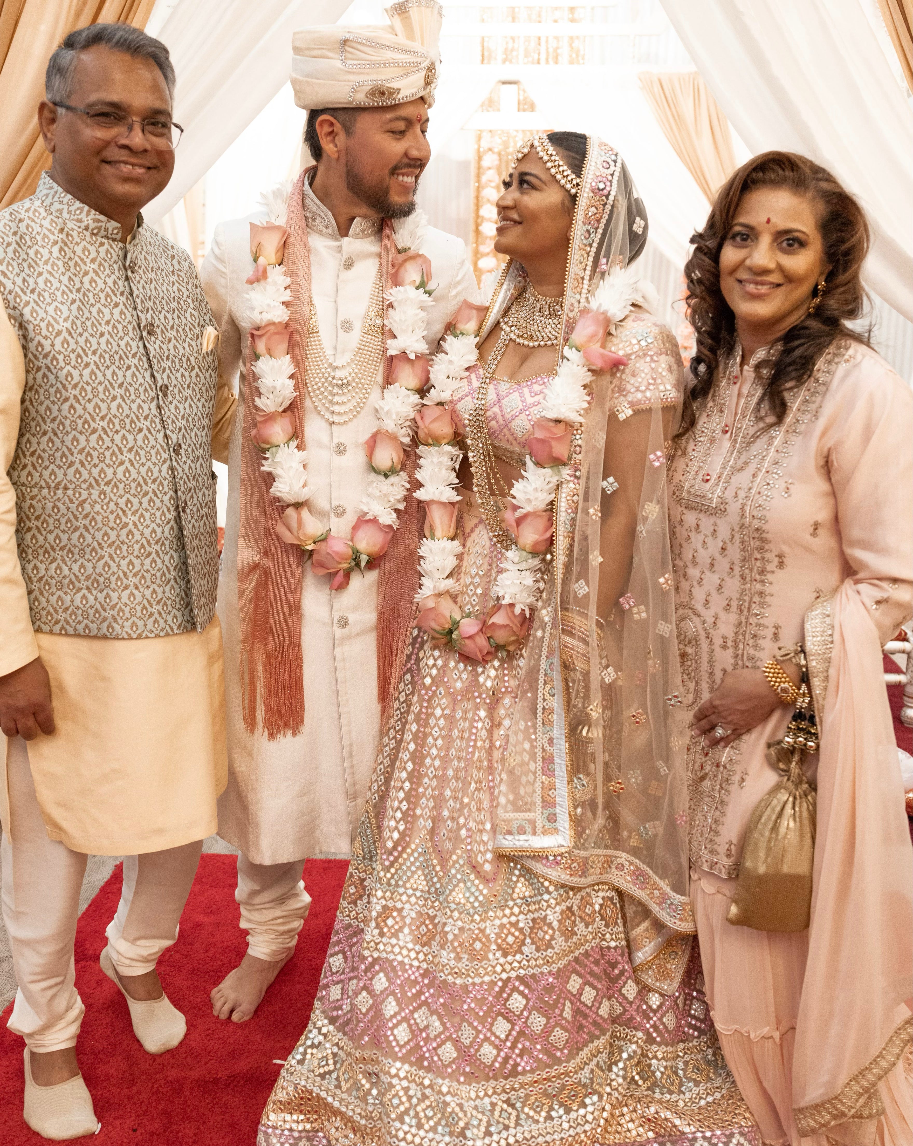 A stunning pastel bridal lehenga with a variety of colors is embellished with exquisite embroidery and mirror work.