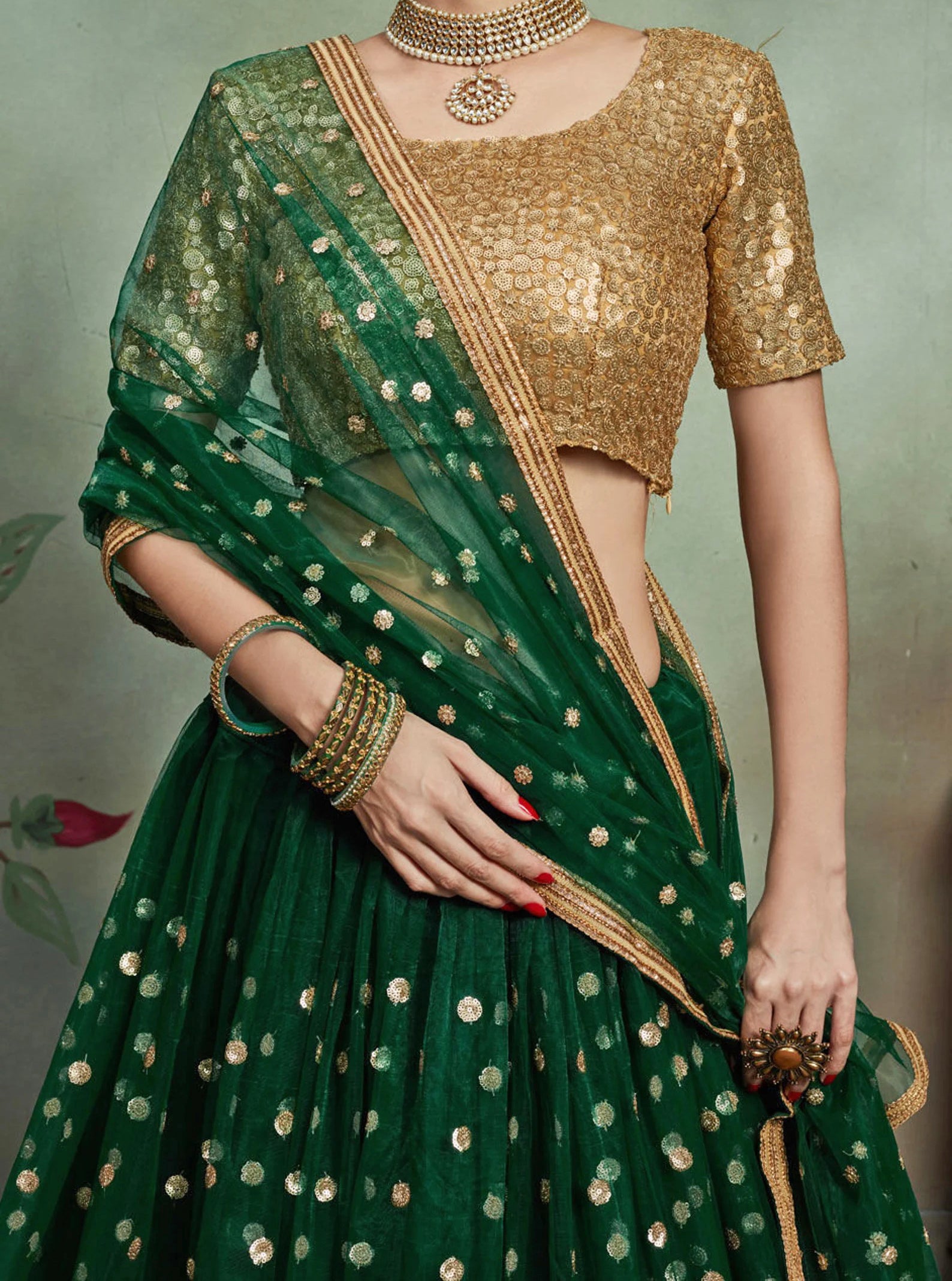 Gorgeous gold and green lehenga. The skirt and dupatta are also embroidered in gold sequined floral style.