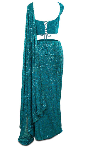 Stunning teal color georgette Saree paired with a sequined sleeveless blouse.