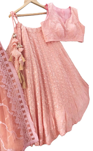 This beautiful peachy pink lehenga, 3-piece lehenga is delicately embroidered with small gold sequins.