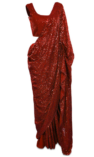 Red georgette Saree is fully covered with sequins and paired with a sequined sleeveless blouse.