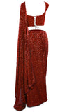 Saree is ready-made and pre-pleated paired with a sequined sleeveless blouse.