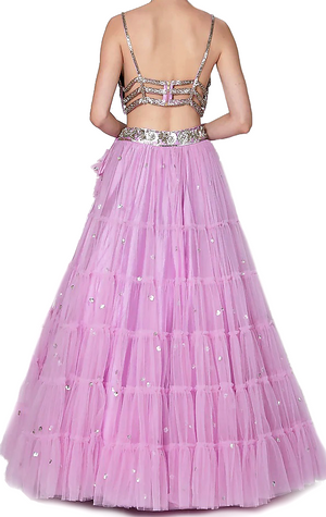 The lehenga has a dupion base with silver sequin embroidery. It is paired with a matching blouse.