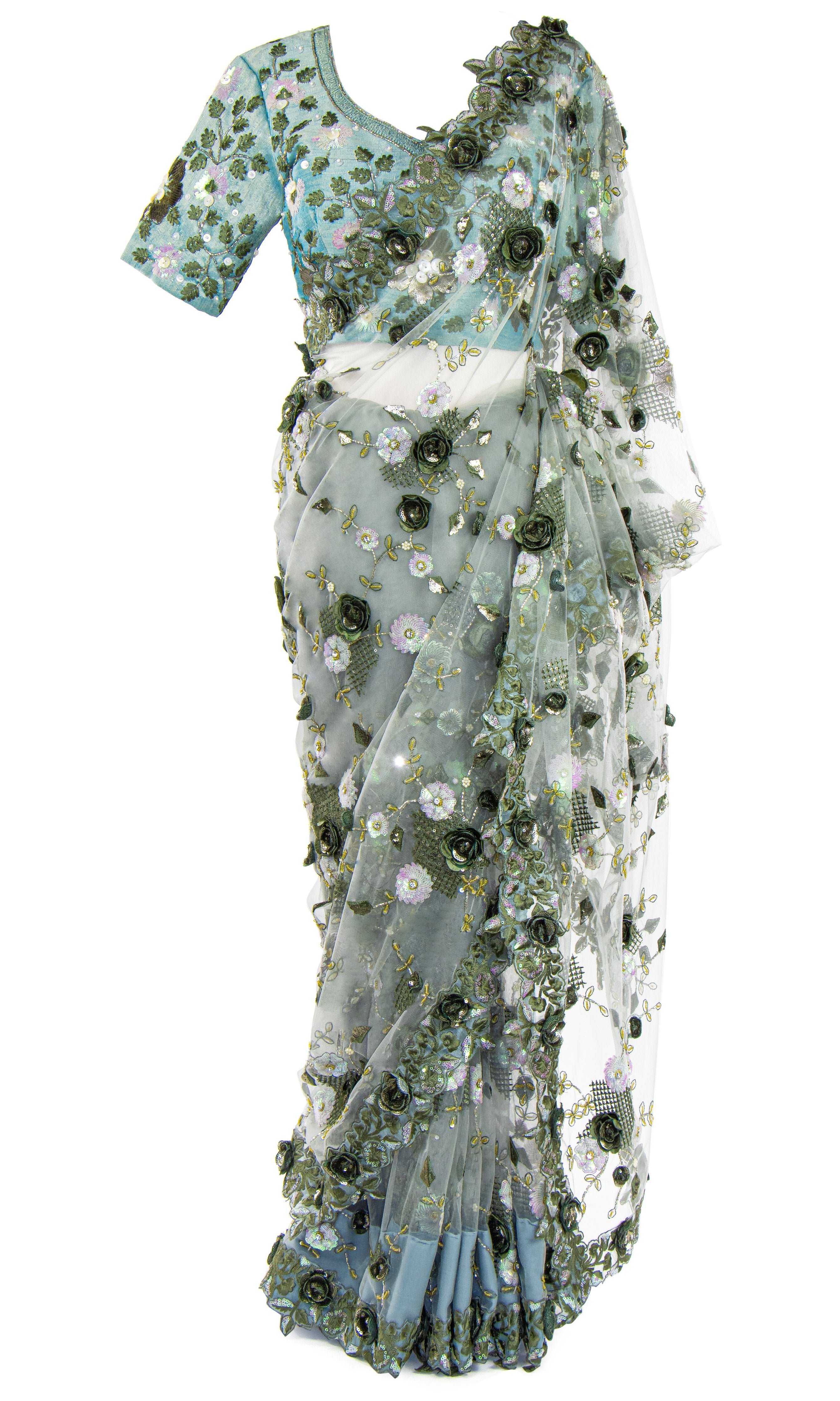 Ready-made and pre-pleated blue silk top is embellished with floral. Paired with a gray net saree.