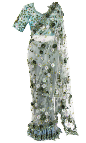 A blue silk top is embellished with floral and vine beading. Paired with a gray net and lace Saree.