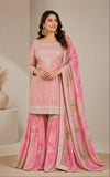 Woman wearing a pink traditional outfit with a matching dupatta in a neutral setting