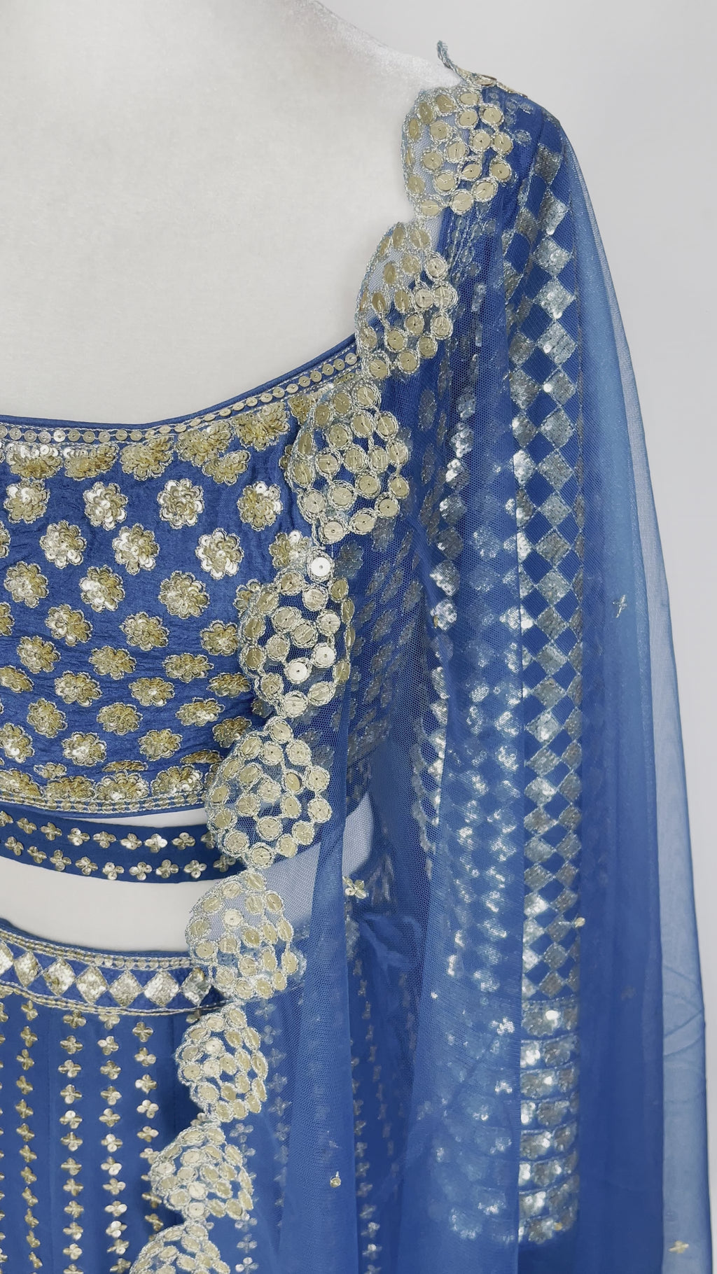 Blue, custom-made designer lehenga with shimmering embroidery by Vani Vats with shimmering gold embroidery
