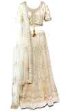 Creme shimmering colored lehenga covered in beautiful embroidery in shades of creme, off-white, gold and silver.