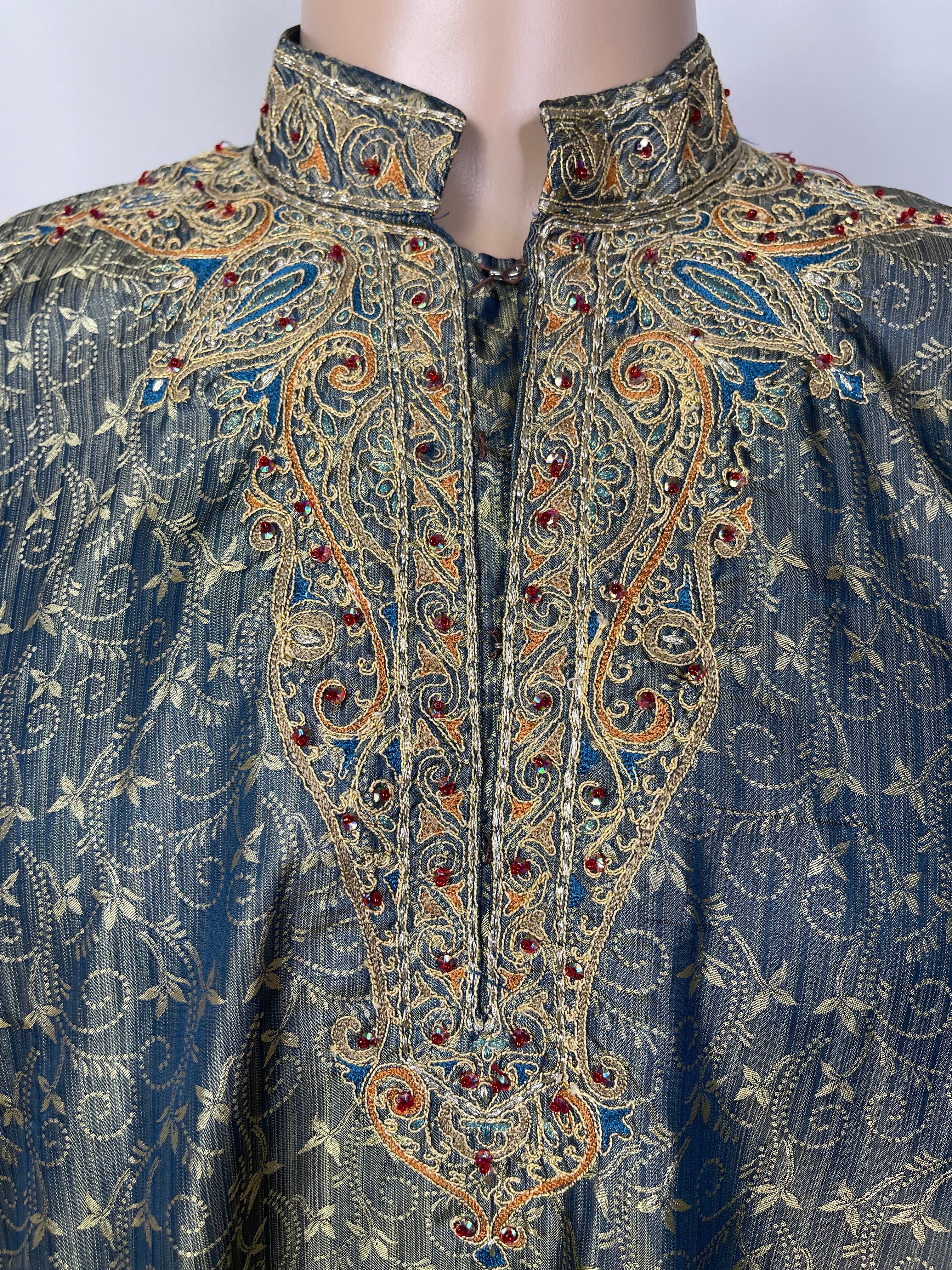 Silk gray and blue kurta paired beautifull gold embroidery and red stones.