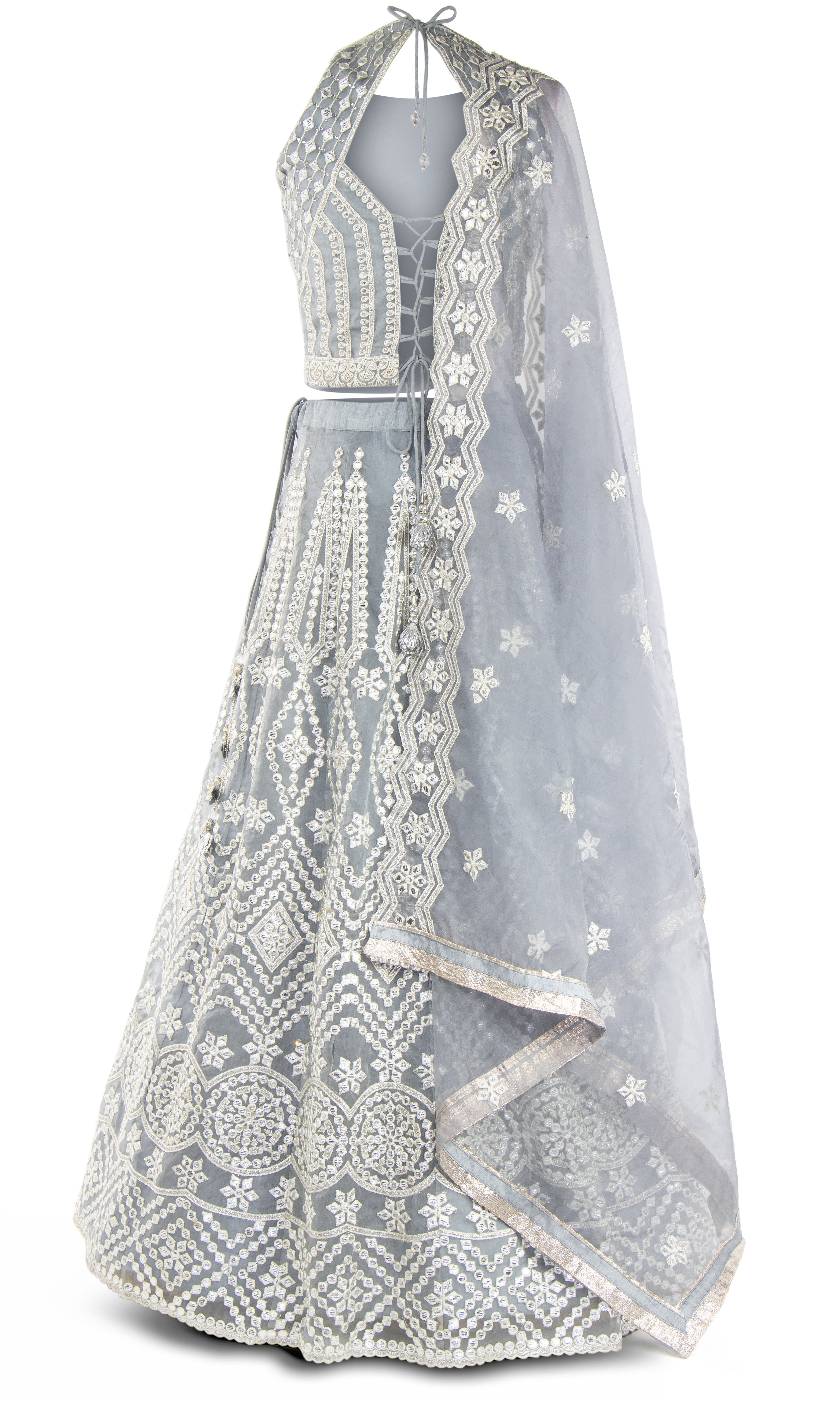 A sleeveless gray lehenga is embellished in a diamond pattern mirror fabric.
