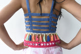 The back of the blouse is open and has room for some stretch. The blouse is jean material.