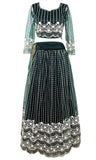 The three-piece, elegant lace lehenga set is forest green in colors and has off-white lace embroidery on it.