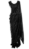 Saree is ready-made and pre-pleated with a plain sleeveless black blouse. 