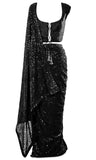 Pre-pleated and ready to wear, the saree comes with a simple, sleeveless black blouse.