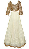 The long-sleeved top is covered entirely in gold sequins, and the lehenga skirt is a creamy tone.