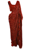 Red georgette Saree is fully covered with sequins and paired with a sequined sleeveless blouse. 