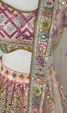 Stunning multi-colored pastel bridal lehenga is covered in beautiful embroidery and mirror work. 